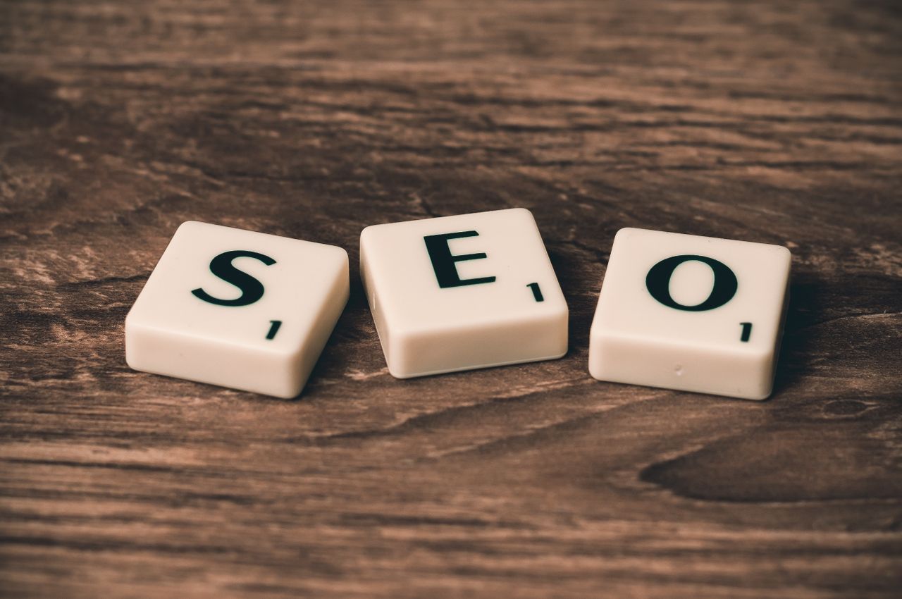creative-03 Scrabble tiles spelling SEO on a wooden surface. Ideal for digital marketing themes.